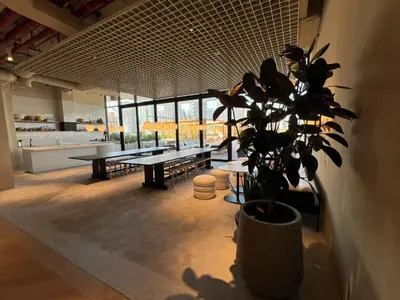a large room with a table and a potted plant at UPSIDE LIVING Downtown Business & Leisure in Dubai