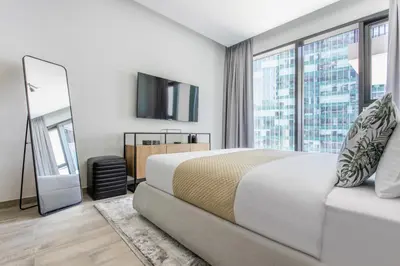 a bedroom with a large bed and a large window at Frank Porter - Ahad Residences in Dubai