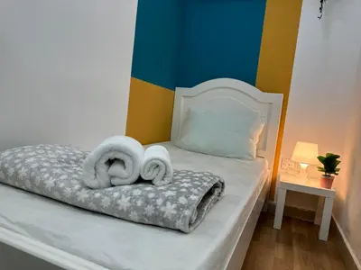 a bedroom with a bed with towels on it at Decent Partition Room in Barsha Heights Near Metro in Dubai