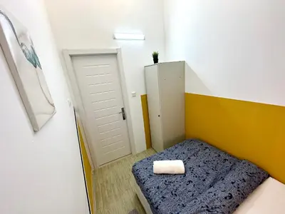 a small room with a bed with a towel on it at lavish Partition Room in Barsha Heights Near Internet City Metro in Dubai