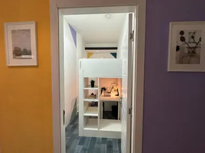 a room with a white closet with shelves at Cozy Loft Partition Room in Barsha Heights in Dubai