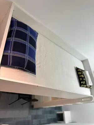 a blue pillow sitting on top of a bunk bed at Cozy Loft Partition Room in Barsha Heights in Dubai