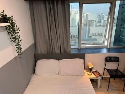 a small bedroom with a bed and a window at Double Partition Room in Al Barsha 1 Nearest to Metro in Dubai
