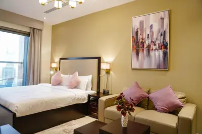 a hotel room with a bed and a couch at Modern Studio, Canal View, Elite Downtown, Dubai - 13AB06 in Dubai