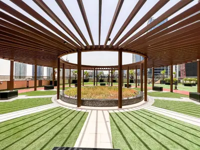 a building with a large wooden structure with a garden at Modern Studio, Canal View, Elite Downtown, Dubai - 13AB06 in Dubai