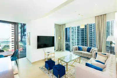 a living room with a couch and a tv at HomesGetaway- 2BRLuxury Apartment at Marina Gate 2 in Dubai