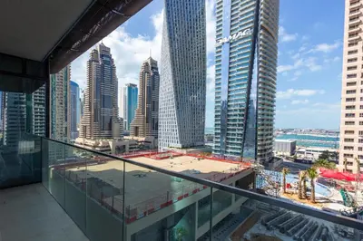 a view of a city from the balcony of a skyscraper at HomesGetaway- 2BRLuxury Apartment at Marina Gate 2 in Dubai