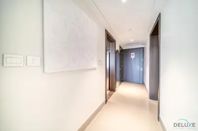 a hallway in a building with a painting on the wall at Plush 2BR at Grand Opera Downtown Dubai by Deluxe Holiday Homes in Dubai