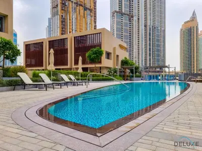a swimming pool in the middle of a city with tall buildings at Plush 2BR at Grand Opera Downtown Dubai by Deluxe Holiday Homes in Dubai