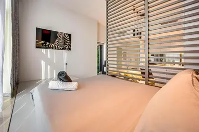 a living room with a couch and a tv on a wall at Amazing Luxury Studio in Dubai in Dubai