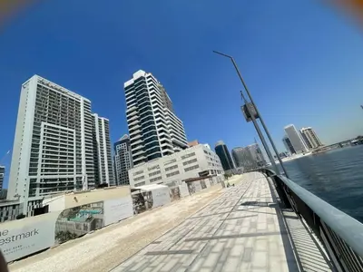a bridge over a body of water with tall buildings at Business Bay Gem1 bd apt with Scenic Canal Views in Dubai