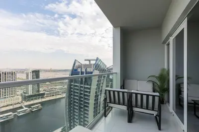 a balcony with a bench and a view of the city at Business Bay Gem1 bd apt with Scenic Canal Views in Dubai