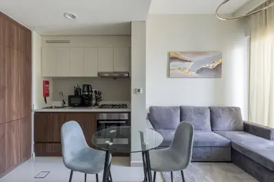 a living room with a couch and a glass table at Business Bay Gem1 bd apt with Scenic Canal Views in Dubai