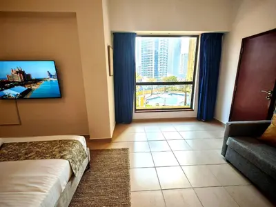 a hotel room with a bed and a large window at Spacious 2BR Apt on JBR Beach near Mall & Metro By La Buena Vida Holiday Homes in Dubai