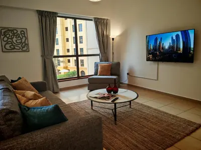 a living room with a couch and a table at Spacious 2BR Apt on JBR Beach near Mall & Metro By La Buena Vida Holiday Homes in Dubai