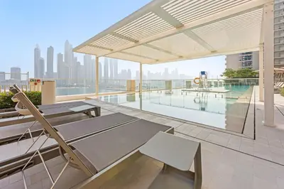 an outdoor patio with a pool on a building at Silkhaus Sea View 1BDR in Marina Vista, near Marina in Dubai