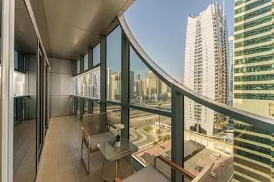 an apartment balcony with a view of a city at Luxe Living in our Exquisite 1 Bedroom Apartment in Dubai