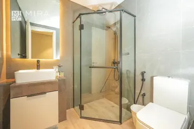 a bathroom with a shower and a toilet and a sink at Mira Holiday Homes - Spacious 2 bedroom in Midtown in Dubai
