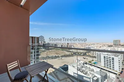 a balcony with a bench and a view of a city at StoneTree - Brand New Studio in Jewelz Residence in Dubai