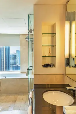 a bathroom with a sink and a glass shower at Seaview & Marina View Studio in Dubai