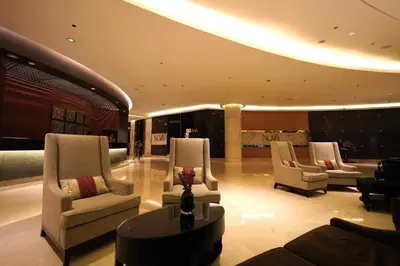 a living room with three chairs and a table at Seaview & Marina View Studio in Dubai