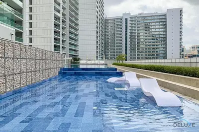 a swimming pool on the roof of a building with buildings at Special Deal Contemporary 1BR with Canal Views by Deluxe Holiday Homes in Dubai