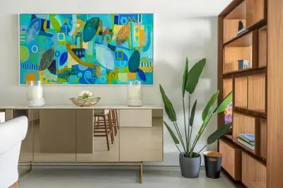 a dining room with a desk with a painting on the wall at GuestReady - Sky-High Dubai Dreamscape in Dubai