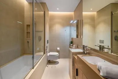 a bathroom with a tub and a toilet and a sink at GuestReady - Sky-High Dubai Dreamscape in Dubai