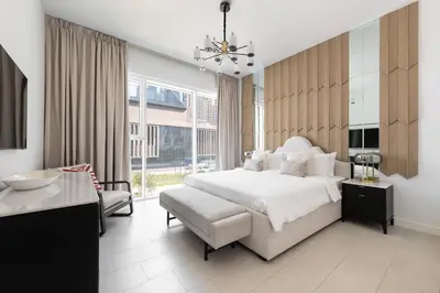 a bedroom with a white bed and a large window at LUXSeaside/2BD/LaVie/JBR in Dubai