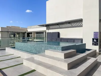 a swimming pool on top of a building at Cosy 1BR in the center of JVC in Dubai