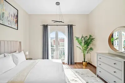 a bedroom with a white bed and a window at Luxury 1 Bedroom Apartment in Discovery Gardens in Dubai