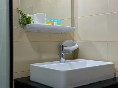 a white sink in a bathroom with a mirror at 35% OFF in Top View Studio w/ Balcony in Marina in Dubai