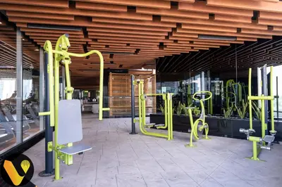 a gym with yellow equipment in a building at Vogue Business Bay, Bayz By Danube close to Downtown, Dubai Mall and Burj Khalifa, Three Bedroom Apartment with Balcony and Burj Khalifa view, Access to all Amenities in Dubai