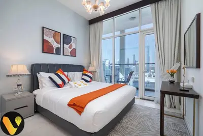 a bedroom with a large bed and a large window at Vogue Business Bay, Bayz By Danube close to Downtown, Dubai Mall and Burj Khalifa, Three Bedroom Apartment with Balcony and Burj Khalifa view, Access to all Amenities in Dubai