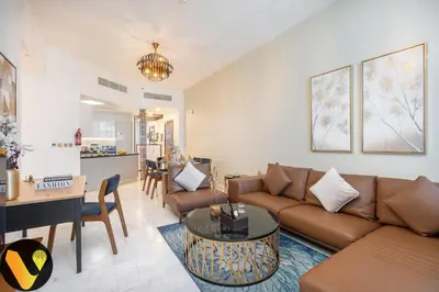 a living room with a couch and a table at Vogue Business Bay, Bayz By Danube close to Downtown, Dubai Mall and Burj Khalifa, Three Bedroom Apartment with Balcony and Burj Khalifa view, Access to all Amenities in Dubai