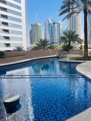 a large swimming pool in a city with tall buildings at Dream Tower 1 in Dubai