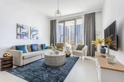 a living room with a couch and a table at Frank Porter - The Grand in Dubai