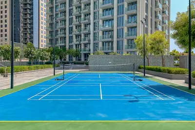 a tennis court in the middle of a city at Frank Porter - The Grand in Dubai