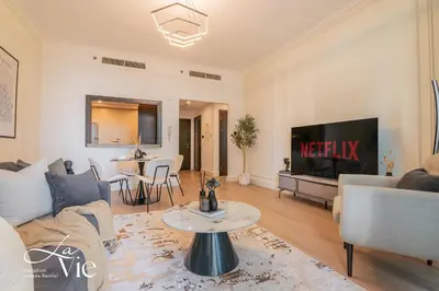 a living room with a couch and a tv at Chic 1 Bed in Marina Newly Furnished,Modern Luxury in Dubai