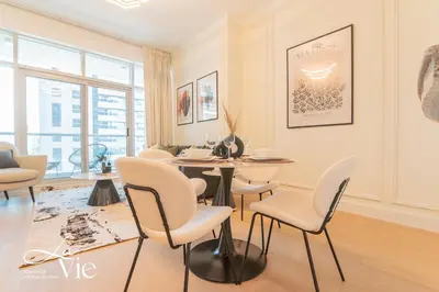a living room with a table and chairs at Chic 1 Bed in Marina Newly Furnished,Modern Luxury in Dubai