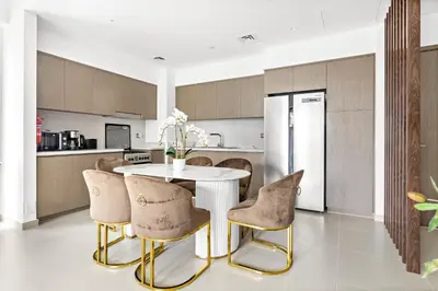 a kitchen with a white table and chairs at Luxury 2 Bedroom Apartment - Next to Dubai Opera in Dubai