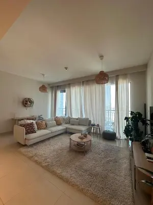 a living room with a couch and a table at Beautiful Flat in Harbor Views in Dubai
