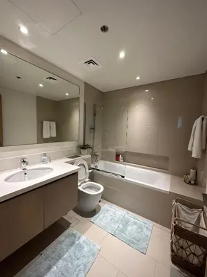 a bathroom with a sink and a toilet and a tub at Beautiful Flat in Harbor Views in Dubai