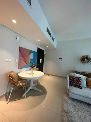 a living room with a table and a couch at Beautiful Flat in Harbor Views in Dubai