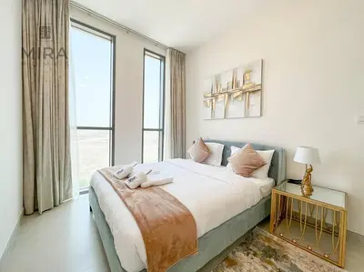 a bedroom with a large bed with two teddy bears on it at Mira Holiday Homes - Serviced 1 bedroom in Midtown in Dubai
