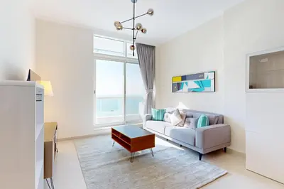 a living room with a couch and a table at Botanica Tower - Bright One Bedroom in Dubai