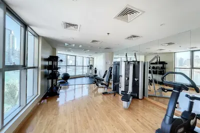 a gym with treadmills and cardio equipment in a building at The Point Tower - Chic One Bedroom in Dubai