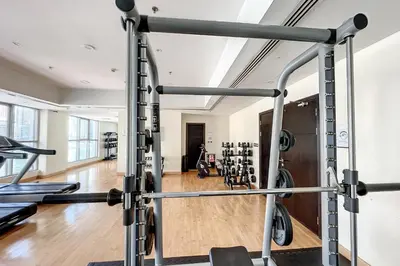 a gym with a bunch of treadmills at The Point Tower - Chic One Bedroom in Dubai