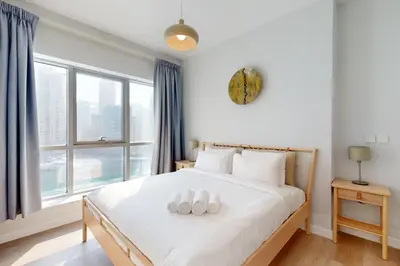 a bedroom with a bed with two white pillows on it at The Point Tower - Chic One Bedroom in Dubai