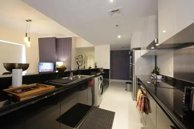 a large kitchen with a sink and a stove at AHH - Panoramic Marina Views - Stylish 2BR at DAMAC Heights in Dubai